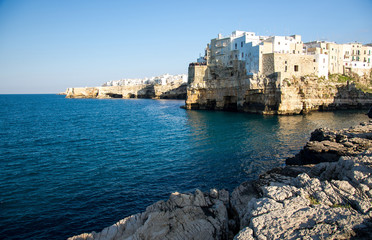 White buildings on grottos and cliffs in the town of Polignano a mare in Puglia Apulia region, Southern Italy