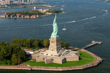 Aerial photograph of the Statue of Liberty taken during the summer with Ellis Island in the...