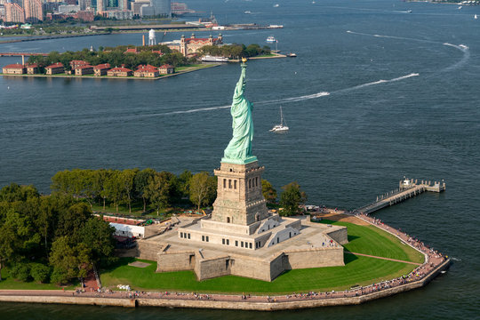 Aerial photograph of the Statue of Liberty taken during the summer with Ellis Island in the background