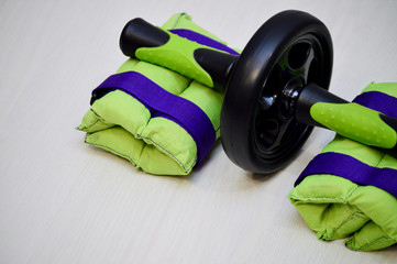 Sports equipment for a healthy sports lifestyle. Dumbbells, hand or foot weights, massage ball, elastic bands, bandages, a roll for the press, an expander hoop and others