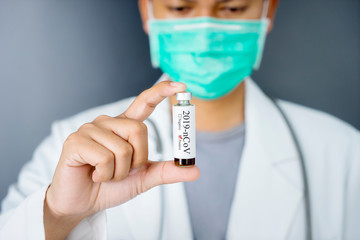 Unidentified doctor holding a nCoV vaccine bottle