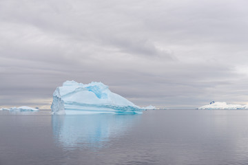Fototapeta na wymiar Antarctic landscape with iceberg, view from expedition ship