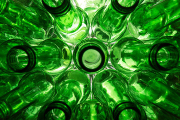 glass beer bottles lie in rows, necks on camera