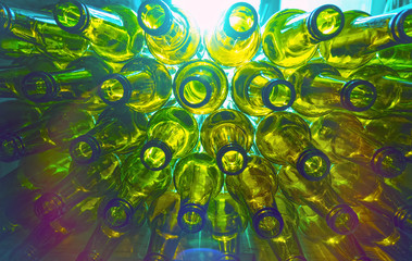 glass empty beer bottles lie in rows, open the necks on the camera