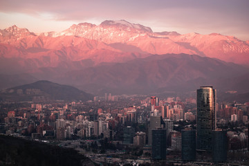 skyscrapers at sunset with mountain