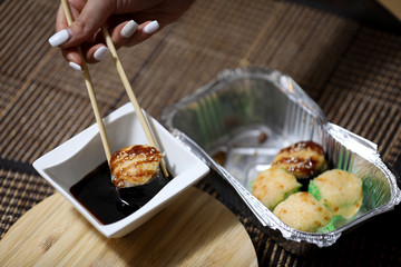 Take away sushi set on a brown background.