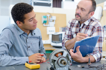 technician and manager maintaining record of server room