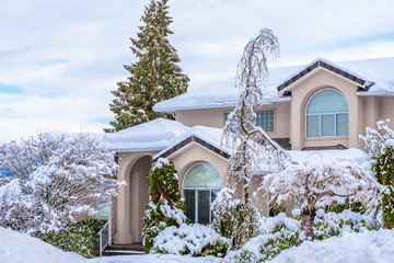 A typical american house in winter. Snow covered.