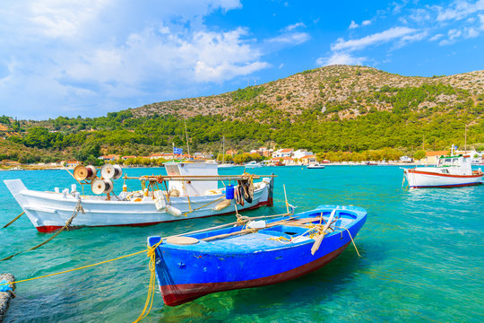 Colourful Greek fishing boats on turquoise sea in Posidonio bay, Samos island, Greece