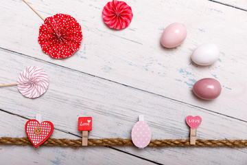 Frame made of easter eggs and spring flowers on white wooden background. Easter composition. top view with copy space