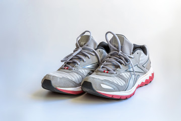 Pair of old sneakers on a white background