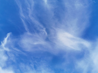 Bright blue sky with clouds, background for design, decoration or wallpaper