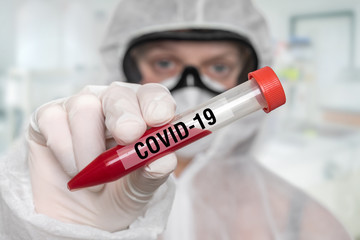 Scientist is holding test-tube on CORONAVIRUS COVID-19
