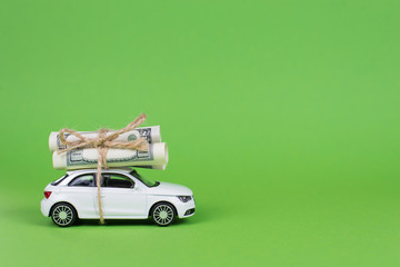 Earn cash with your car concept. Side profile full photo picture of small white car with rolls piles of usd money on top isolated bright color background with copyspace card