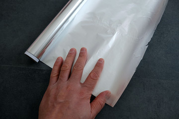 aluminum foil, rolled aluminum foil, close-up on a black background,