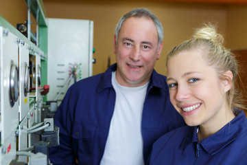 Fototapeta premium couple of workers have relax time near to machine