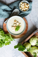 Creamy celery and kohlrabi soup topped with croutons and served with wholemeal bread