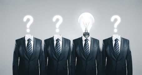 Businesspeople with lightbulb and question marks