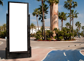  Billboard, banner, empty, white in the city center with street with palm trees, green plants and bicycle lane