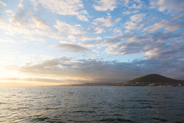 Golden sunset in the sky over the Avacha Bay, Kamchatka Peninsula, Russia.