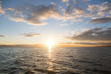 Obraz premium Golden sunset in the sky over the Avacha Bay, Kamchatka Peninsula, Russia.