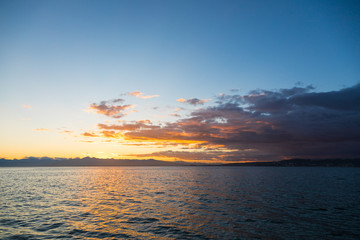 Golden sunset in the sky over the Avacha Bay, Kamchatka Peninsula, Russia.