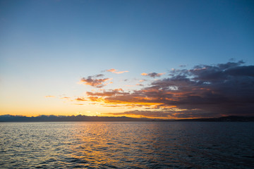 Golden sunset in the sky over the Avacha Bay, Kamchatka Peninsula, Russia.