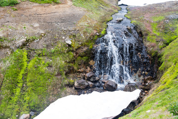Small Valley of Geysers, Kamchatka Peninsula, Russia. This is a unique active fumarole field, the hot gases of which pass through the water of a cold stream, heating it and creating a gushing effect.