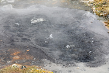 Small Valley of Geysers, Kamchatka Peninsula, Russia. This is a unique active fumarole field, the hot gases of which pass through the water of a cold stream, heating it and creating a gushing effect.