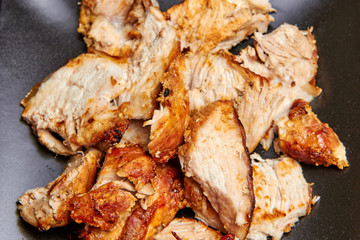 baked meat cut into pieces close up photo