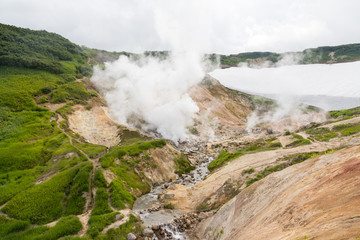 Small Valley of Geysers, Kamchatka Peninsula, Russia. This is a unique active fumarole field, the hot gases of which pass through the water of a cold stream, heating it and creating a gushing effect.