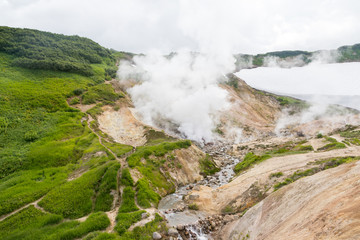 Small Valley of Geysers, Kamchatka Peninsula, Russia. This is a unique active fumarole field, the hot gases of which pass through the water of a cold stream, heating it and creating a gushing effect.