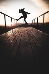 silhouette of man on bridge