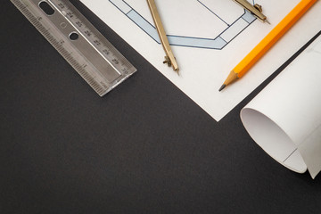 Rolled house diagrams and accessories for drawing lying on construction drawing
