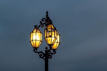 Fototapeta na wymiar Historical lamp post in Valletta, Malta with three bulbs, one of them is broken