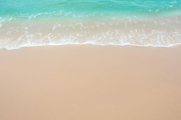 Naklejka na ściany i meble Summer beach concept - Soft wave of sea on empty sandy beach Background with copy space.
