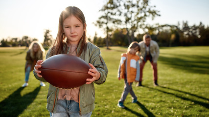 Fun time together. Happy family spending time in the park on a sunny day