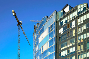 Fototapeta premium Development of modern glass and steel skyscraper
