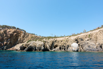 Fototapeta na wymiar Rocky coast and gorgeous waters in Kelyfos islet, Marmaras, Chalkidiki, Greece