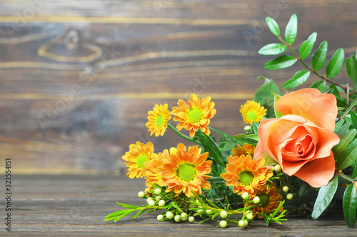 Mothers Day flowers on wooden background with copy space