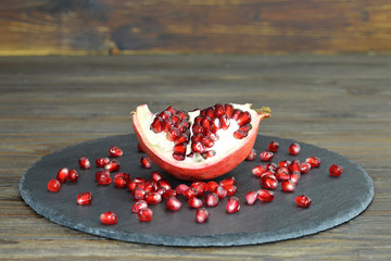 Piece of pomegranate on black slate
