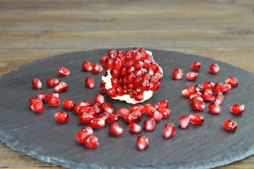 Piece of pomegranate on black slate