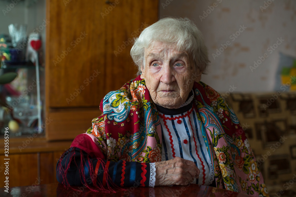 Wall mural An old elderly woman in Cossack clothes in his house.