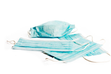 a pile of surgical masks sometimes used for protection from airborne viruses like corona virus