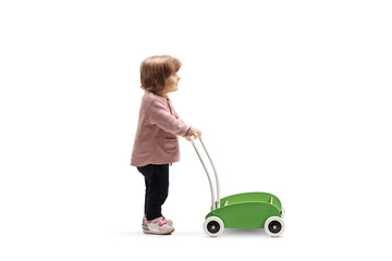 Little girl with a toy push cart