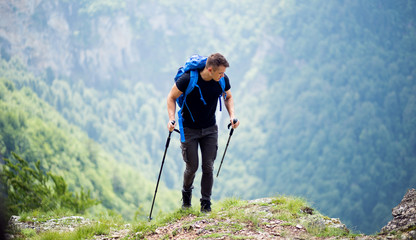 Handsome male hiker with backpack enjoy in nature