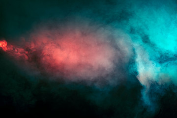 Abstract texture of backlit smoke in red blue on a black background.