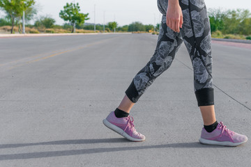 Woman walking with pink tennis over concrete and sportswear