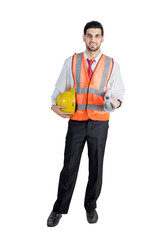 Male engineer holding helmet and paper