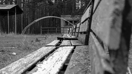Wooden benches in an abandoned children's camp.